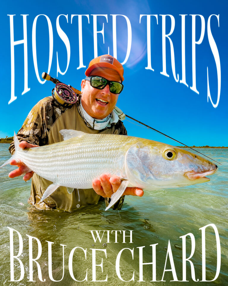 Man in an orange cap holding a large fish in shallow water, with a fishing rod visible and bold 'HOSTED TRIPS' text overhead.